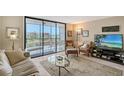 Cozy living room with a sliding glass door that opens to an outdoor patio at 2045 Gulf Of Mexico Dr # M1-207, Longboat Key, FL 34228
