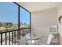 Outdoor patio with seating and a view of the beach and ocean at 2045 Gulf Of Mexico Dr # M1-207, Longboat Key, FL 34228