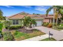 Well-maintained home with a tile roof, manicured landscaping, and a brick driveway at 212 River Enclave Ct, Bradenton, FL 34212