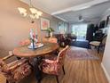 Inviting dining room with elegant chandelier, wooden floors, and seamless transition to living area at 2207 Sunset Dr # E5, Bradenton, FL 34207