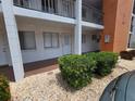 Condo exterior featuring a covered entryway with well-kept landscaping, and neutral paint at 2207 Sunset Dr # E5, Bradenton, FL 34207