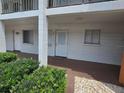 Inviting condo exterior with well-maintained landscaping and covered entryway leading to the front door at 2207 Sunset Dr # E5, Bradenton, FL 34207