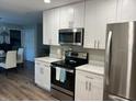 Modern kitchen with stainless steel appliances, white cabinets, and ample counter space at 2726 Knoll E St, Palm Harbor, FL 34683