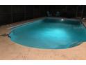 Sparkling in-ground pool illuminated at night, perfect for relaxation and outdoor enjoyment at 2726 Knoll E St, Palm Harbor, FL 34683