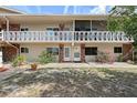 Inviting condo building featuring a balcony, well-maintained grounds, and charming curb appeal at 3705 S School Ave # 3, Sarasota, FL 34239