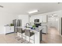 Bright kitchen with stainless steel appliances, marble countertops, and a center island with seating at 3924 Candia Ave, North Port, FL 34286