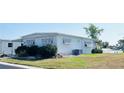 A charming home showcasing a picturesque view of the serene lake at 415 Oakwood W Blvd, Sarasota, FL 34237
