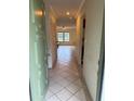 Inviting entryway with tile flooring, coat closet, and an open view into the living area at 5014 Barrington Cir # 2102, Sarasota, FL 34234