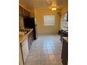 Spacious kitchen featuring tile floors, a window, and standard appliances with ample cabinet space at 5014 Barrington Cir # 2102, Sarasota, FL 34234