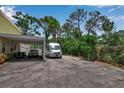 Spacious driveway featuring covered parking with an open design and enough space for multiple vehicles at 508 Howard Ct, Sarasota, FL 34236