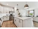 Bright kitchen with white cabinets, stainless steel appliances, and large island at 5117 Marina Basin Ct, Bradenton, FL 34211