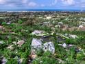 Scenic aerial view showcasing the community's waterfront homes, canals, and the Gulf of Mexico in the distance at 5132 Jungle Plum Rd, Sarasota, FL 34242