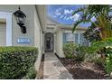 Inviting front entrance with lush landscaping and a decorative address plaque, creating a warm welcome at 5320 Tide Point Way, Bradenton, FL 34208