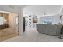 Bright and airy living room with white tile floors seamlessly connects to other living spaces in this open concept layout at 5320 Tide Point Way, Bradenton, FL 34208