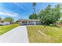 Charming single-story home with a well-maintained lawn and covered parking area at 5710 16Th W St, Bradenton, FL 34207