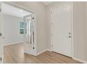 Bright foyer featuring wood-look flooring and a view into a room through glass-paned french doors at 5985 Amberly Dr, Bradenton, FL 34208