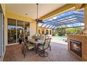 Outdoor patio with a fireplace and ample seating, ideal for entertaining guests year-round at 6143 9Th Avenue Ne Cir, Bradenton, FL 34212