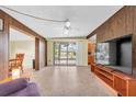 Inviting living room with a sliding glass door to the front porch and view into kitchen and dining area at 6628 Auburn Ave, Bradenton, FL 34207