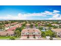 An aerial view shows the townhouse community with a serene pond, mature trees, and neatly arranged residential buildings at 7346 Skybird Rd # 417, Bradenton, FL 34209