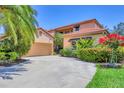 Beautiful two-story home with tile roof, spacious driveway and landscaped front yard at 7551 Calle Facil, Sarasota, FL 34238