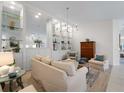Bright living room featuring elegant built-in shelving, comfortable seating, and stylish decor at 7641 Quinto Dr, Sarasota, FL 34238