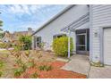 The front entrance features a trellis, screen door, and minimal landscaping at 8160 Glenbrooke Ct, Sarasota, FL 34234