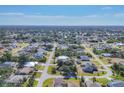 Expansive aerial shot showcases a quiet residential area with lush trees and well-spaced homes at 9366 Westminster Ave, Englewood, FL 34224