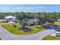 Aerial view of a well-maintained home with mature trees and landscaping in a peaceful neighborhood at 9366 Westminster Ave, Englewood, FL 34224