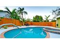 Sparkling pool and spa surrounded by a privacy fence and lush tropical landscaping at 1010 68Th Nw St, Bradenton, FL 34209