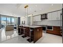 Bright kitchen with stainless steel appliances, a center island with seating, and modern cabinetry at 111 S Pineapple Ave # 813, Sarasota, FL 34236