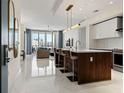 Open concept living space featuring a modern kitchen, dining and sitting area and light, reflective floors at 111 S Pineapple Ave # 813, Sarasota, FL 34236