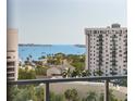 Scenic waterfront view from the condo, featuring boats, lush greenery and surrounding buildings at 111 S Pineapple Ave # 813, Sarasota, FL 34236
