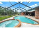 Screened-in pool and spa with outdoor patio area perfect for entertaining or relaxing at 140 Cowpen Ln, Sarasota, FL 34240