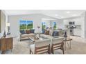 Open-concept living room flows seamlessly into kitchen with views of backyard at 155 Swift St, Port Charlotte, FL 33954