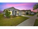 View of home showcasing well-kept lawn and proximity to other residences at 16746 Parker River St, Wimauma, FL 33598