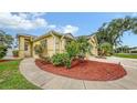 Charming home featuring a well-manicured lawn, lovely landscaping and a walkway to the front door at 203 28Th W St, Palmetto, FL 34221