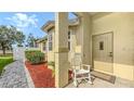 Inviting front porch area with a rocking chair and a landscaped walkway at 203 28Th W St, Palmetto, FL 34221