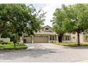 Attractive home with a three-car garage and a well-maintained front yard and landscaping at 20316 Natures Corner Dr, Tampa, FL 33647