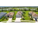 Aerial view highlighting the home's location with lush greenery and serene lake views at 2240 Crystal Lake Trl, Bradenton, FL 34211