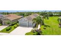 A beautiful aerial view shows the well-manicured lawn and mature landscaping of this attractive home at 2240 Crystal Lake Trl, Bradenton, FL 34211
