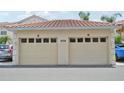 Two-car garage with tile roof features individual doors marked 'B' and 'D' with address at 4254 Vicenza Dr # B, Venice, FL 34293