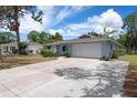 Home with an attached two car garage and a large concrete driveway at 4405 Linwood St, Sarasota, FL 34232