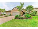Charming single-story home with lush landscaping, mature palms, and a two-car garage at 4416 Amalfi Ave, Sarasota, FL 34243