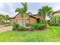 Charming single-story home with lush landscaping, mature palms, and a two-car garage at 4416 Amalfi Ave, Sarasota, FL 34243