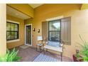 Inviting front porch with cozy seating, decorative shutters, and a charming exterior at 4416 Amalfi Ave, Sarasota, FL 34243