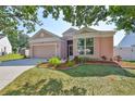 Inviting home featuring a lovely landscaped yard, a two-car garage, and a screened entrance at 4627 56Th E Dr, Bradenton, FL 34203
