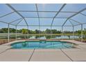 Screen-enclosed pool overlooking tranquil pond, perfect for relaxing and enjoying the outdoors at 4627 56Th E Dr, Bradenton, FL 34203