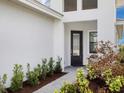 Stylish front entrance showcases a decorative glass door, landscaped walkway, and a bright exterior at 4927 Carova Way, Bradenton, FL 34211