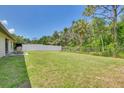 Expansive backyard with lush lawn, partially fenced with both chainlink and privacy fencing at 5530 21St Street E Ct, Bradenton, FL 34203