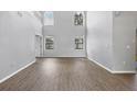 Spacious living area featuring beautiful flooring, abundant natural light, and a clean, modern aesthetic at 5561 Burnt Branch Cir, Sarasota, FL 34232